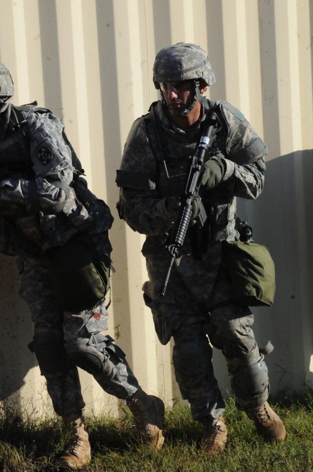 Soldiers make their way through mock village