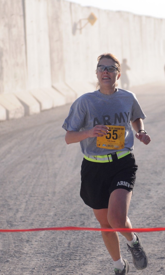 Female winner of the Task Force Spartan 10-Miler run crosses the finish line
