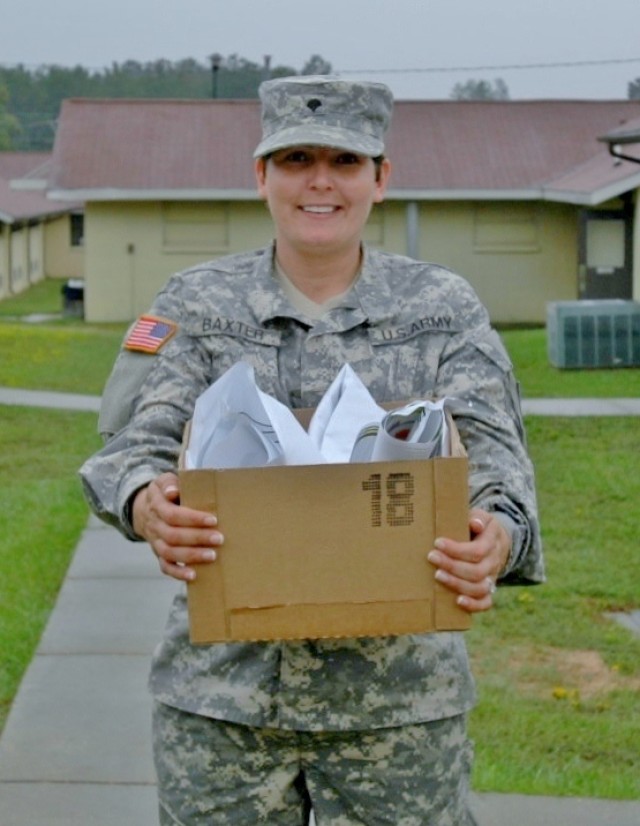 Spc. Heather Baxter, HHD, 177 AR BDE, takes recyclable paper to the Camp Shelby Recycling Center