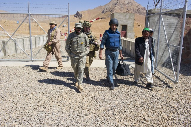 Afghan National Police Lt. Col. Khan enters the compound