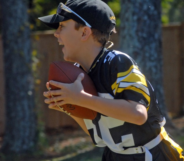 Kohl Kraus Runs The Ball During A Flag Football Game
