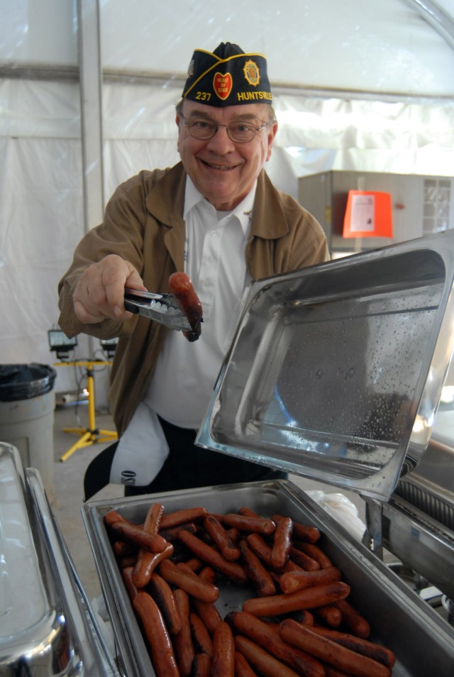 A Volunteer From American legion Post 237 Hands Out Hot Dogs