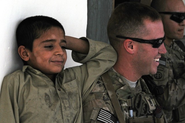 82nd Airborne Division medic interacts with Afghan child