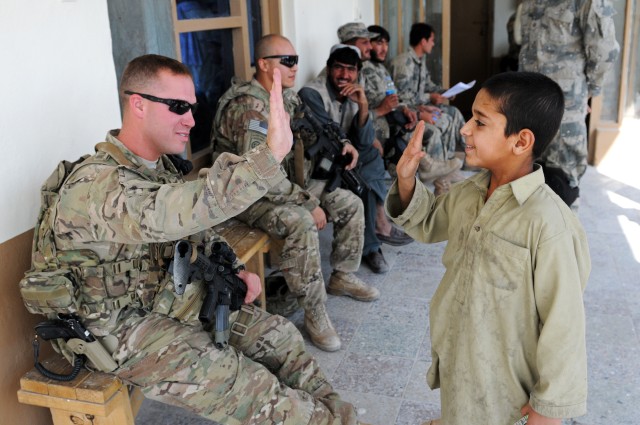 82nd Airborne Division medic high-fives Afghan boy