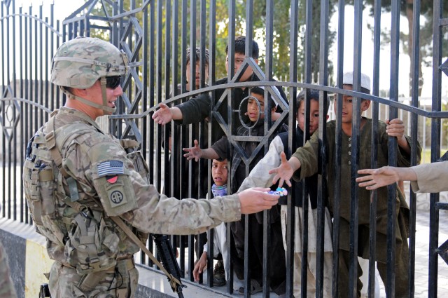 82nd Airborne Division medic hands out toys to Afghan children