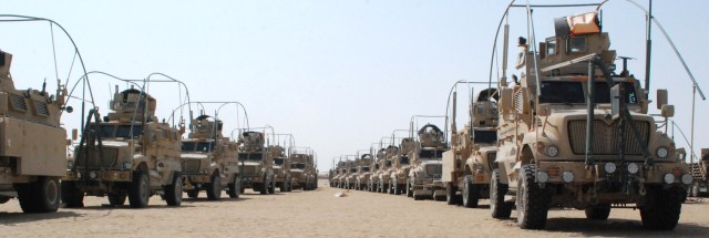Tactical vehicles from Iraq await transport.