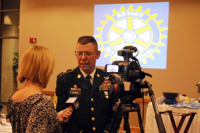 Command Sgt. Maj. Stephen Blake speaks with a reporter