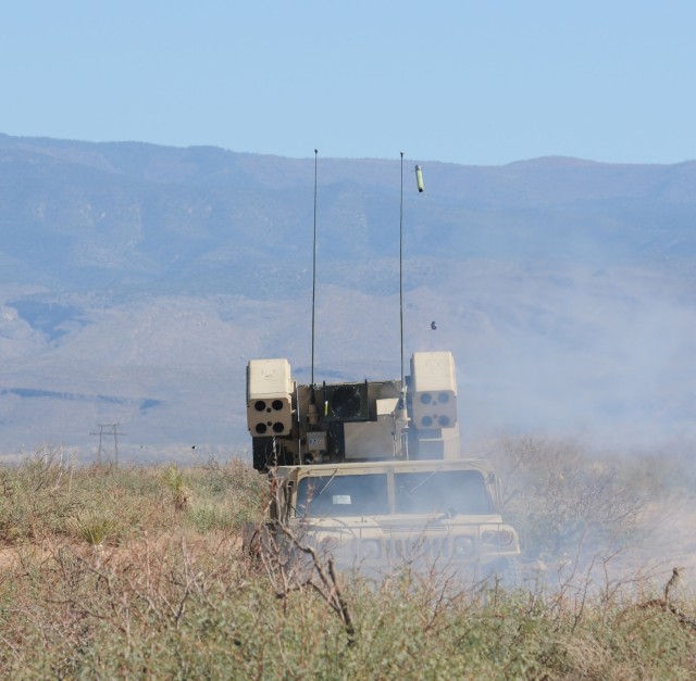 Driving Humvee with mounted Avenger