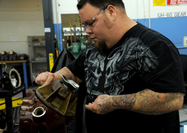 CCAD mechanic works on UH-60 gearbox part