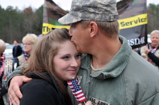 Husband hugs wife