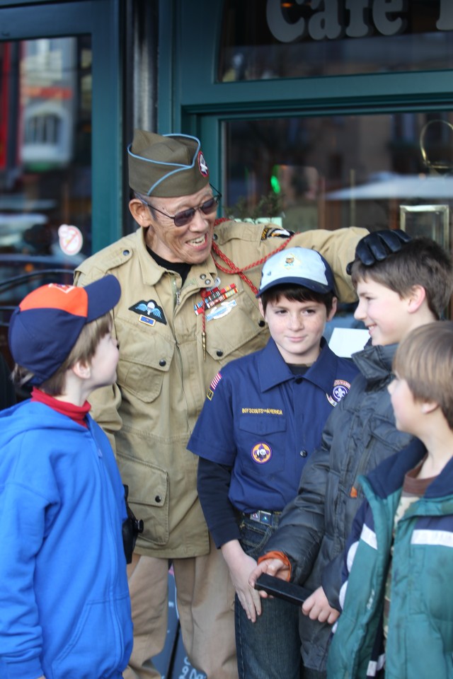 Scouts walk in Bastogne with World War II veterans
