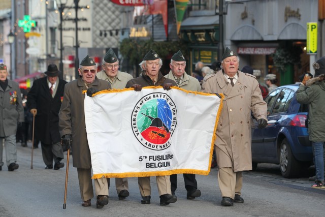 Scouts walk in Bastogne with World War II veterans