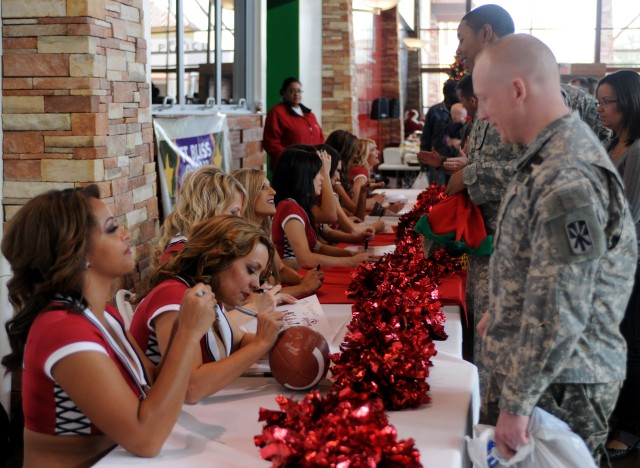 Cheerleaders sign autographs for troops