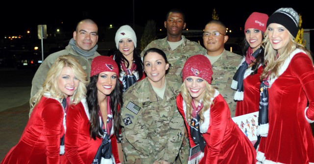 Cheerleaders pose with the troops