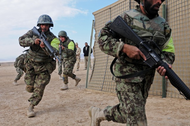 Afghan National Army NCOs demonstrate violence-of-action while clearing a compound