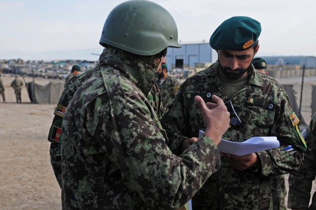 Afghan National Army 205th Corps Command Sgt. Maj. Kafayatullah is briefed by a soldier in Zabul