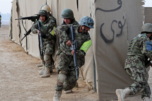 Afghan National Army NCOs demonstrate movement as a squad while clearing compounds in Zabul