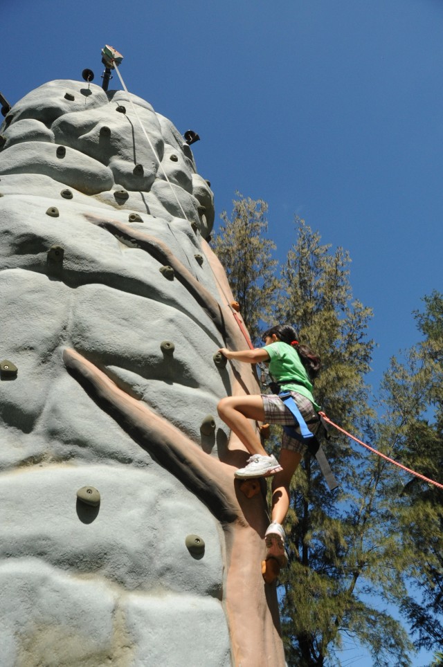 Military kid climbing high