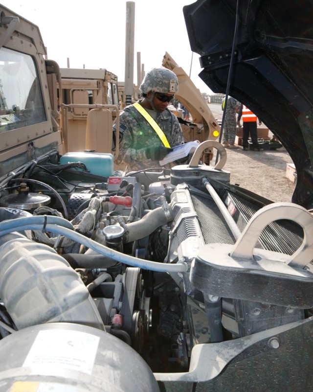 Ironhorse Brigade Soldiers conduct preventive maintenance checks and services during equipment draw operations at Camp Arifjan, Kuwait, Jan. 3.  Army Field Support Battalion-Kuwait, 402nd Army Field S