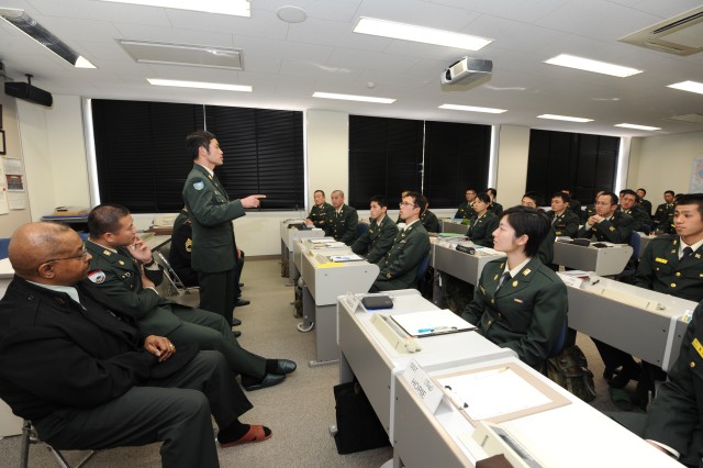 Co-op members brief English students at Camp Kodaira