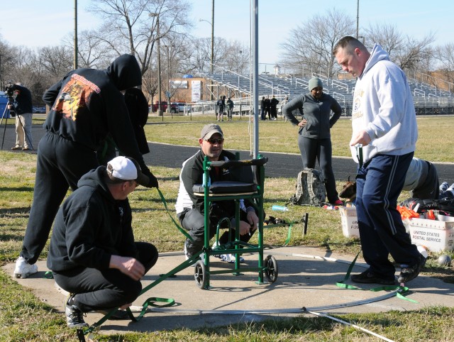 Coach sets chair for shot put