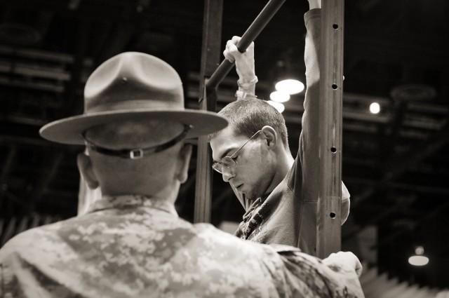 Staff Sgt. Robert L. Olson III ensures proper form during Pull-Up Competition