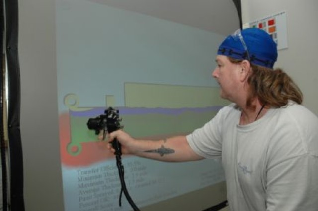 Depot artisan, Mike Holley, demonstrates the Virtual Reality Paint Simulator at Corpus Christi Army Depot.