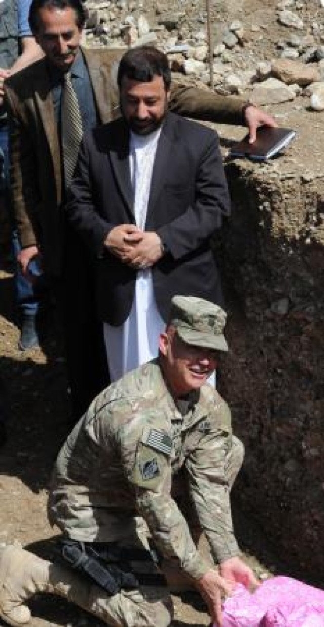 Lt. Col. Gordon "Mark" Bartley, USACE Afghanistan Engineer District-South, places a cornerstone during the groundbreaking for two fire stations in Herat City