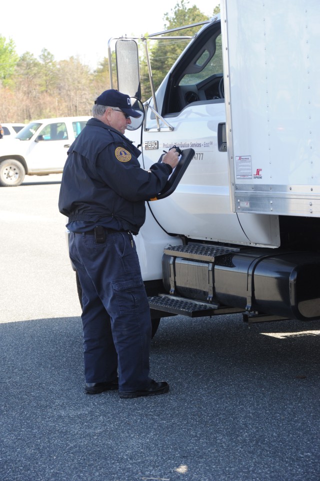John Griffin, Department of Motor Vehicles, Size and Weight Compliance agent, obtains details from a motor carrier operator for his safety inspection report.