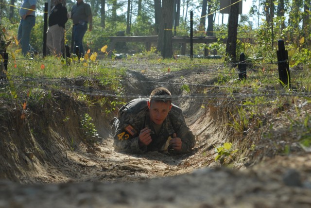 Capt. Josh Bobbitt, Team 43, low crawls during the obstacle course.