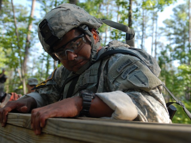 Army Sgt. 1st Class Vince Castellanos climbs an obstacle during the Best Ranger Competition