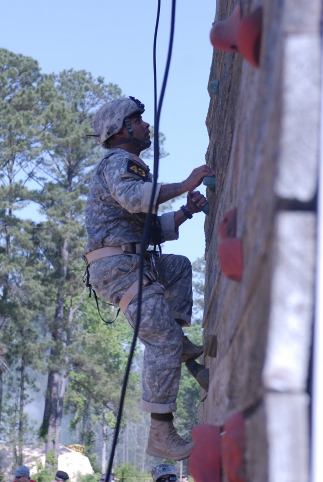 Army Sgt. 1st Class Vince Castellanos climbs up the side of the tri-tower during the Best Ranger Competition