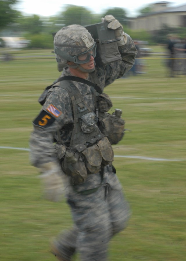 A competitor carries an ammo can during the Leadership Challenge at the Best Ranger Competition