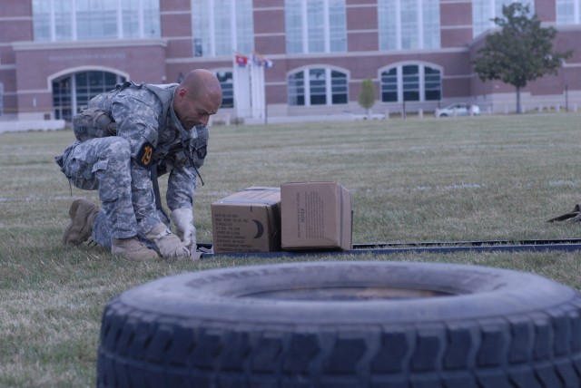 Army Capt. Jason DeRosa builds a litter to carry equipment during the Best Ranger Competition