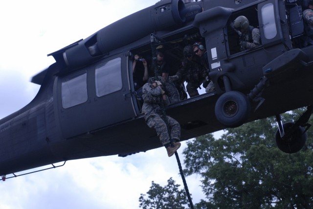 Team 9 member conducts a fast rope insertion/extraction system from a UH60 Blackhawk helicopter during the Best Ranger Competition