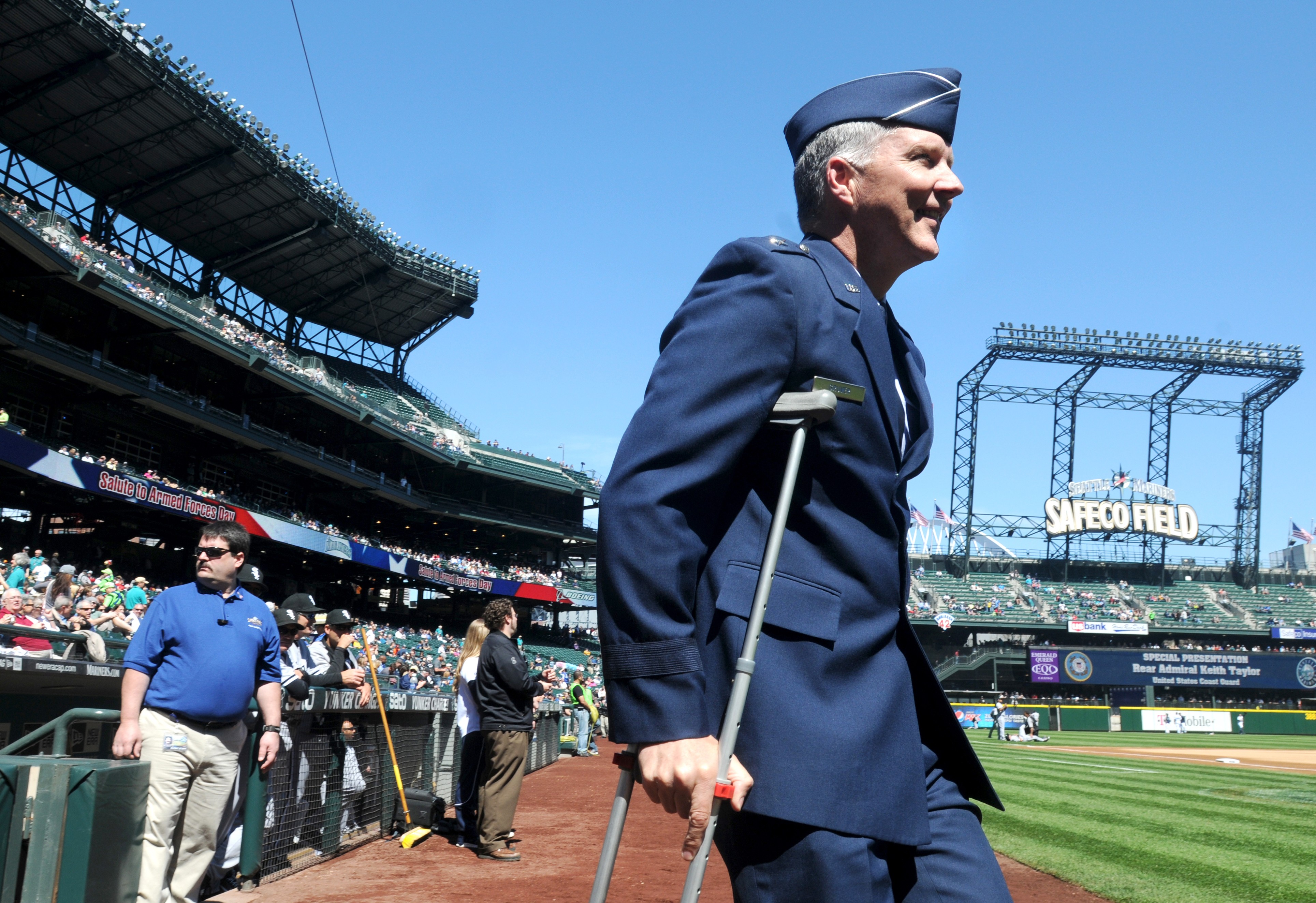 A man salutes during the national anthem before a baseball game