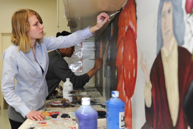High school students at Camp Zama paint mural that illustrates history of physics