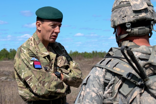 Colonel Richard Smith, the British Military Assistant Military Attach&eacute;, speaks with a Soldier from the 1st Squadron, 89th Cavalry Regiment 