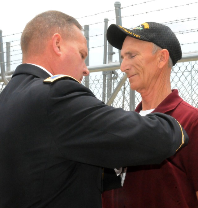Emotional Moment -- Central Technical Support Facility Safety Officer Craig Jones chokes back tears as CTSF Director COL John C. Matthews pins the Combat Aircrew insignia on his chest in a May 31 cere