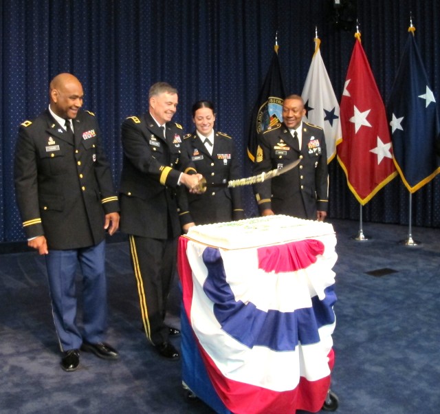 PMILDEP LTG Phillips raises the saber after cutting the Army birthday cake on 12 June, 2012