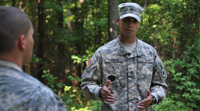 Drill Sergeant Disla offers encouragement to Soldier at DSOY competition