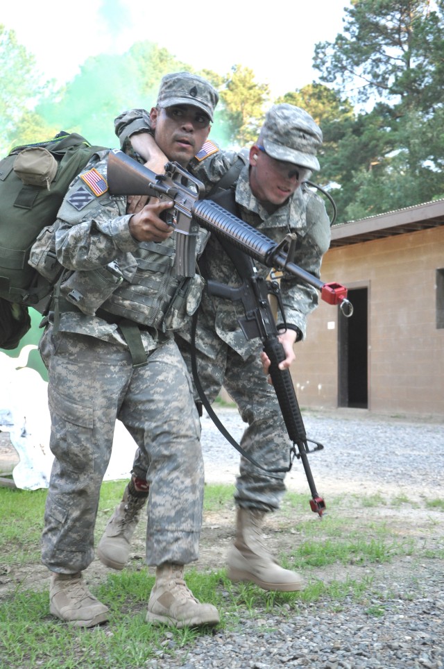 Drill Sergeant Marquez takes an 'injured Soldier' to safety during DSOY competition