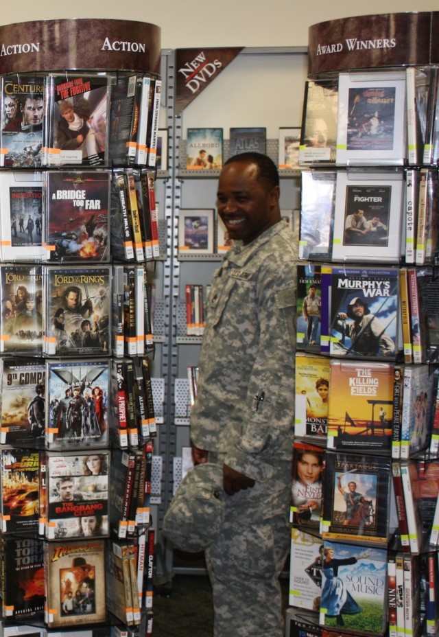 Soldier looks at DVD selection at newly remodeled library
