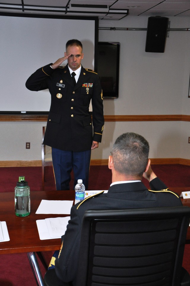 Drill Sergeant Moss salutes IMT Command Sgt. Maj. Calpena at CSM board during DSOY competition