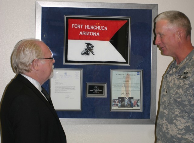 On July 2 at Alvarado Hall, Maj. Gen. Gregg Potter, commanding general of the U.S. Army Intelligence Center of Excellence and Fort Huachuca, recognizes a flag presented by Congressman Ron Barber.