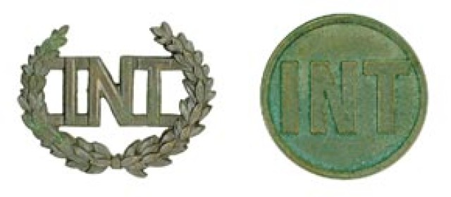 The brass insignia of the Corps of Interpreters