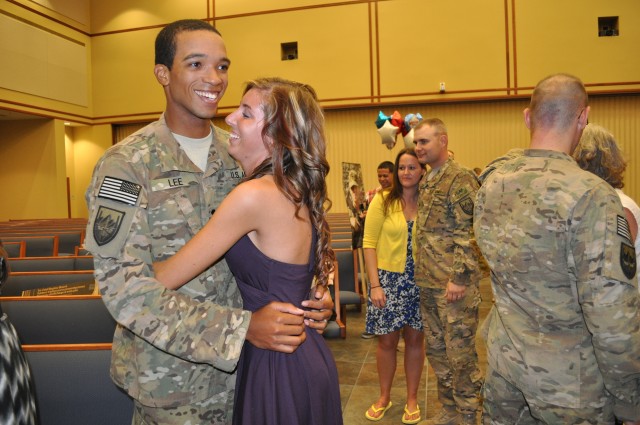 Soldier embraces wife after yearlong deployment