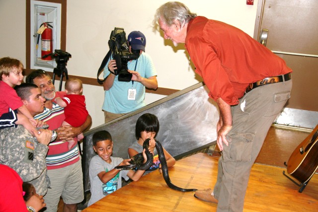 Teaches environmental stewardship with songs, snakes to Hunter youth