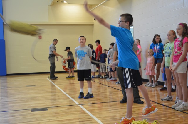 Children practice throwing water safety rescue bags