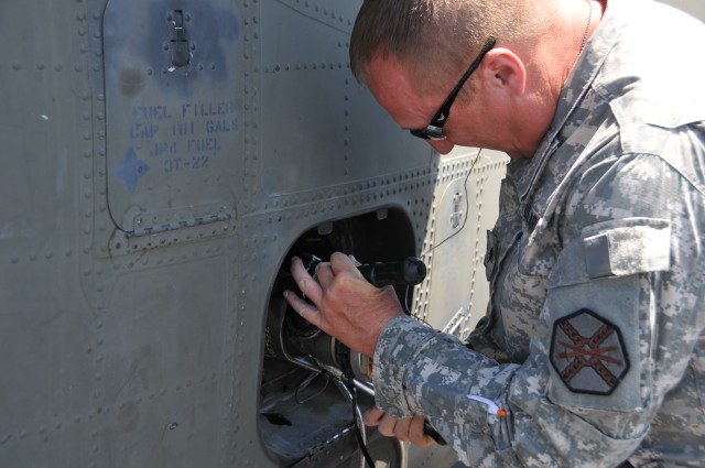 SPC Dennis Snay refuels a Blackhawk helicopter at Fort Hunter Liggett